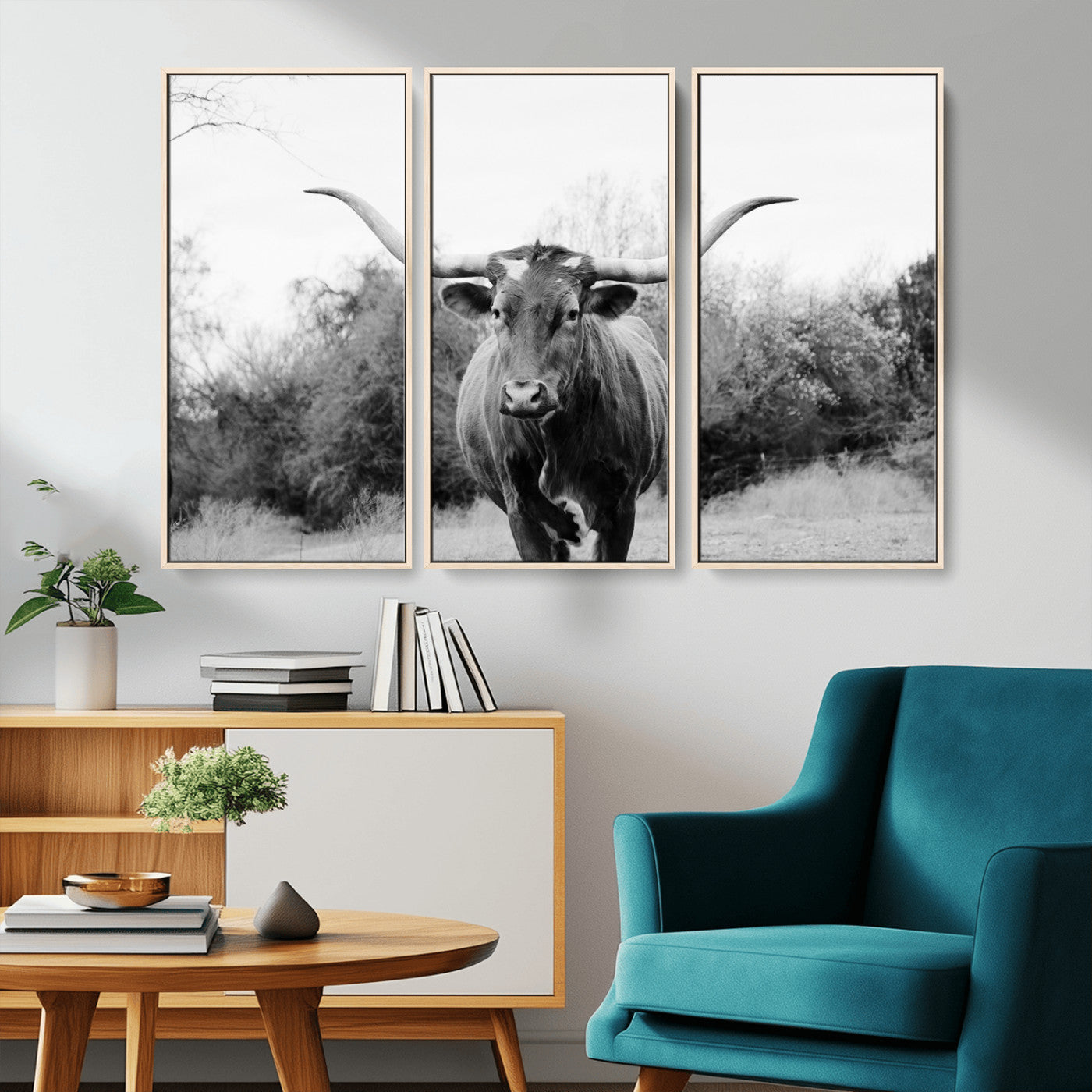 Black and white photo of a longhorn cow in a field, perfect for rustic farmhouse or western-themed interior wall decoration.