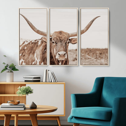 A longhorn cow in soft beige desert tones, standing calmly in open land, perfect for neutral western or rustic farmhouse interiors.