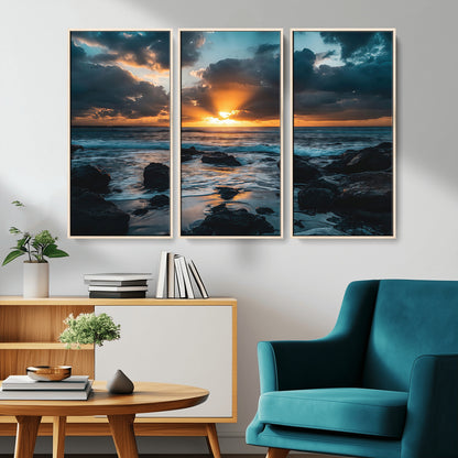 An awe-inspiring sunset over the ocean with rays of light piercing through dramatic clouds, creating a beautiful seascape with rocks in the foreground.