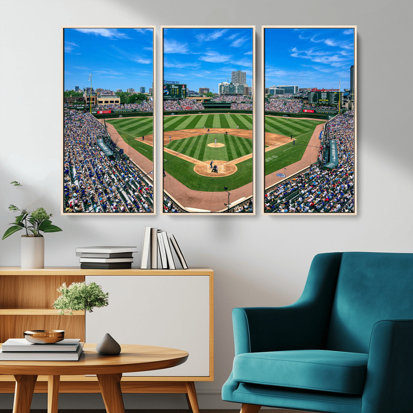 A wide-angle shot of a baseball field filled with spectators, with players on the field and the iconic Wrigley Field scoreboard in the background.