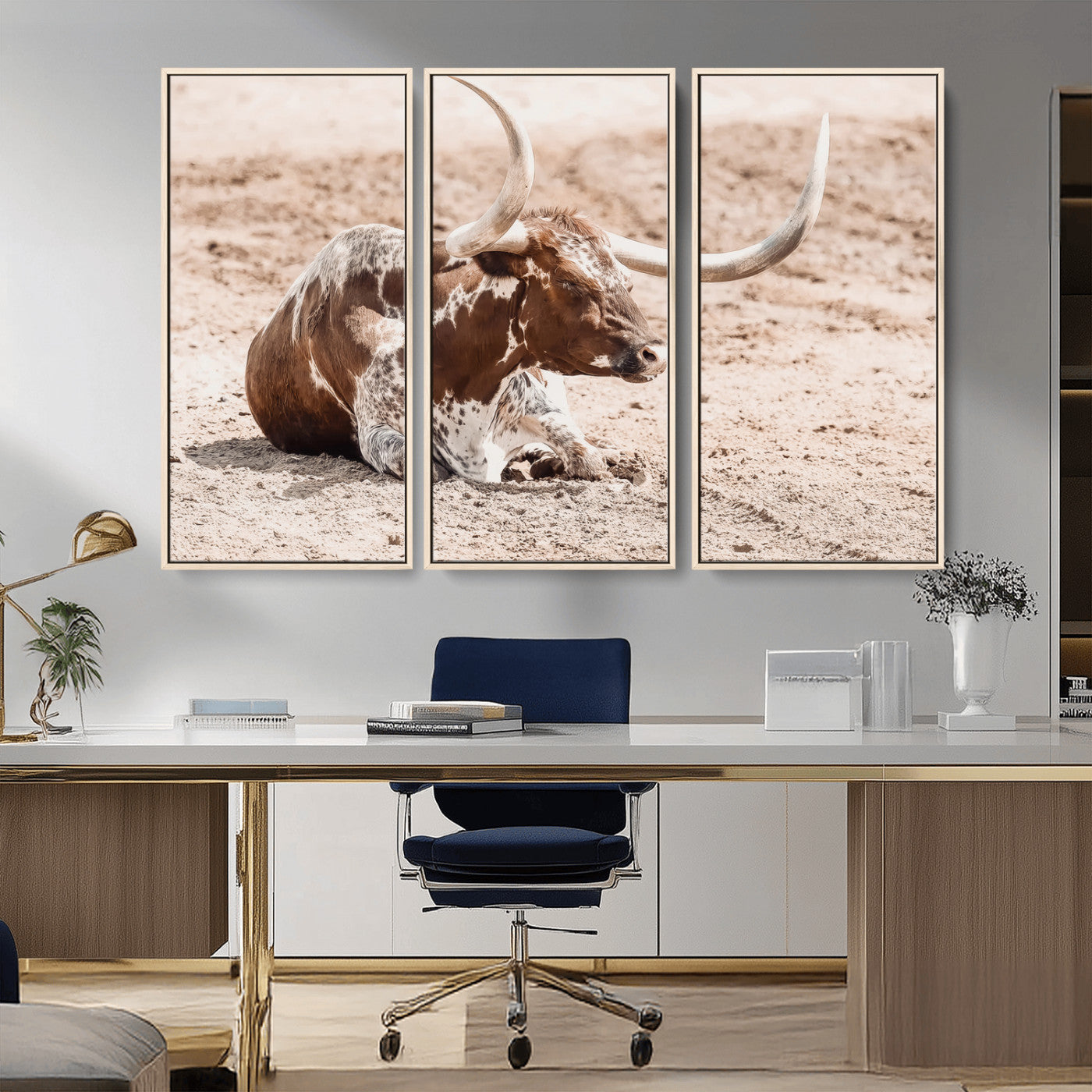 Texas Longhorn bull resting on dusty ground with warm tones, ideal for rustic western or farmhouse-themed wall decor.