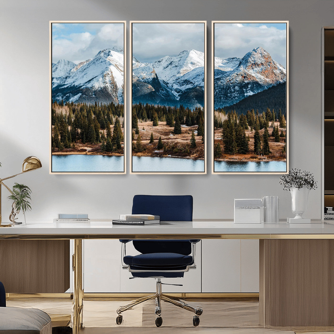 Framed canvas of snowy mountain peaks with pine forest and alpine lake, perfect for winter cabin or wilderness-inspired home decor.