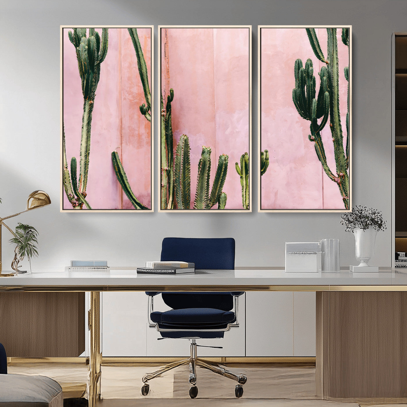 Framed canvas of tall green cacti against a soft pink wall, ideal for modern desert or colorful southwest-inspired home decor.