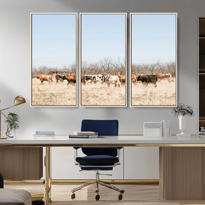 Framed wall art of Texas longhorn cattle walking through a dry, neutral-toned prairie, perfect for rustic farmhouse or western-themed home decor.