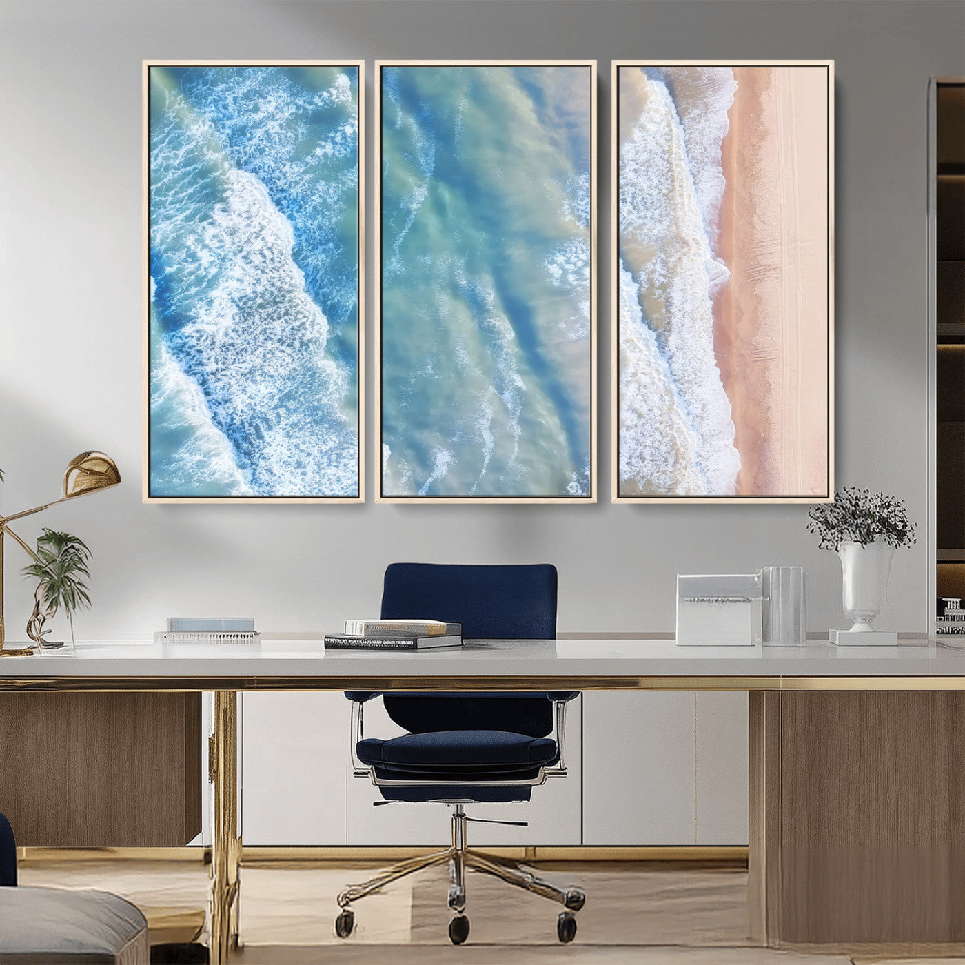 Aerial photo of soft blue waves meeting sandy shore, perfect for modern coastal or beach-themed decor with a light and tranquil aesthetic.