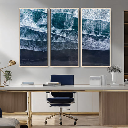 Canvas of aerial ocean waves crashing onto a black sand beach in moody tones, ideal for modern coastal or minimalist home decor.