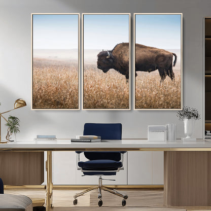 A majestic bison standing in an open prairie field, its strong form blending into the golden grass under a vast blue sky, evoking the wild spirit of the American plains.