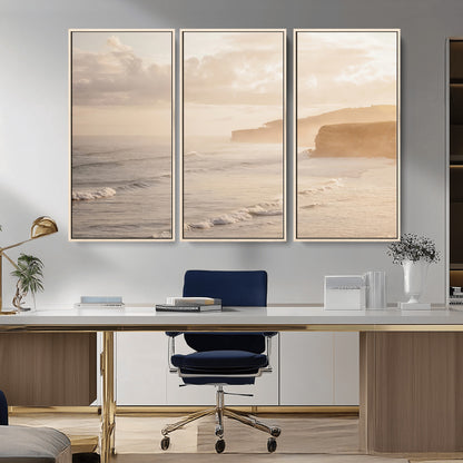 Golden hour seascape with misty cliffs and gentle waves rolling towards the shore, capturing a tranquil and warm coastal atmosphere.
