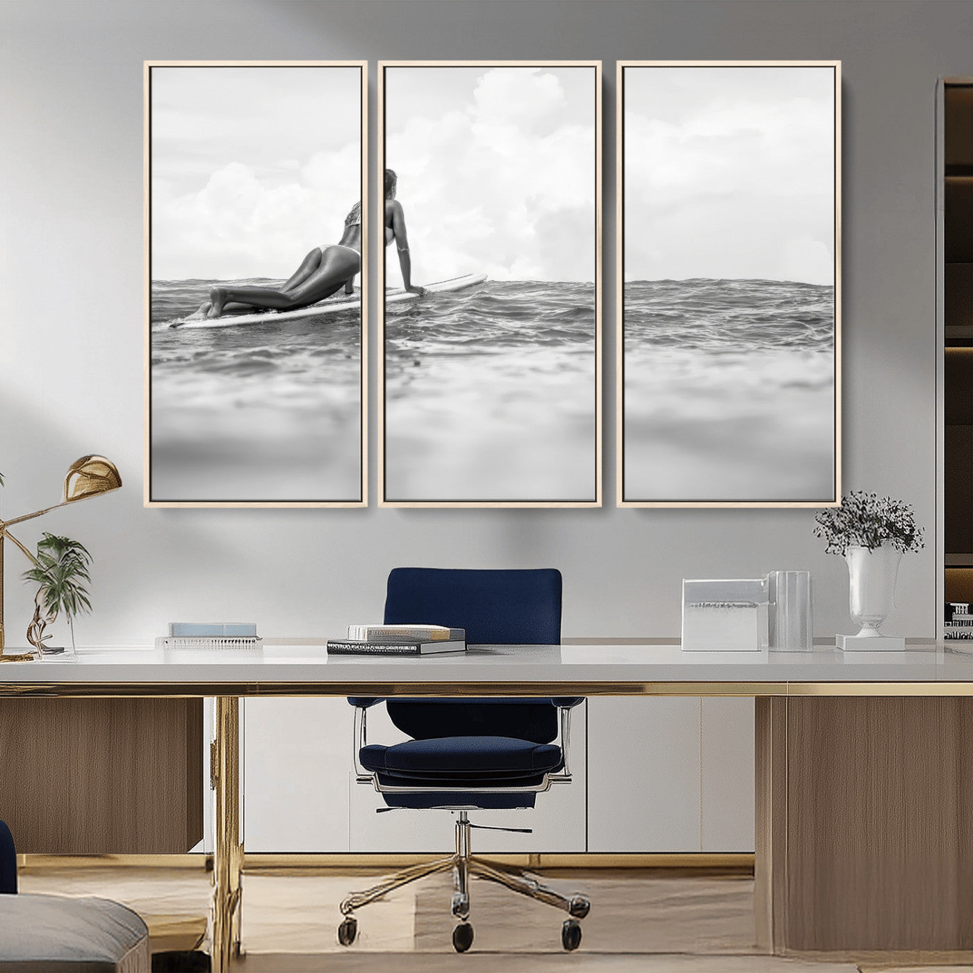 A black and white ocean scene featuring a surfer girl waiting on her board, gazing at the horizon, capturing a tranquil and adventurous coastal moment.