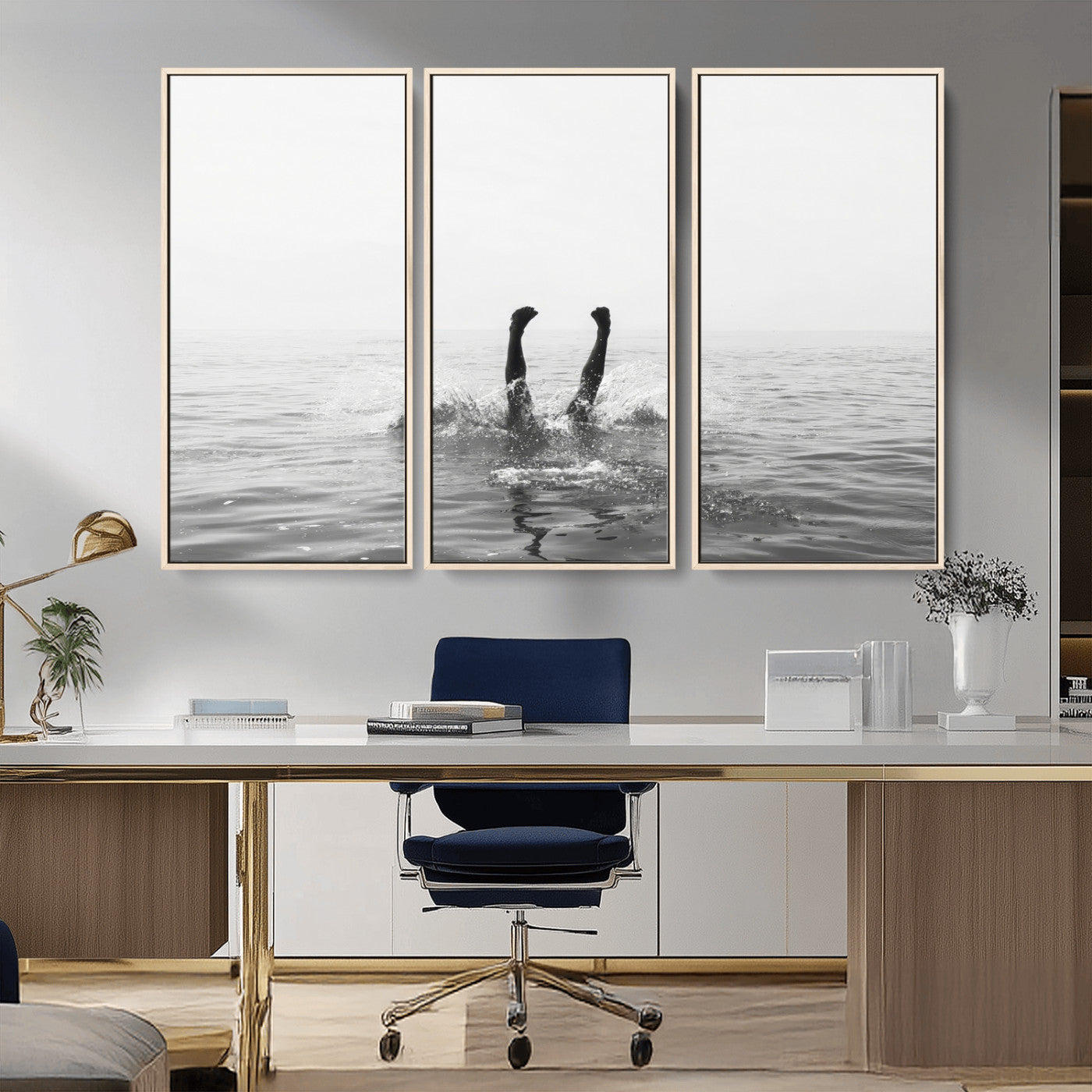 A black and white minimalist water scene capturing a playful splash as a swimmer dives upside down, creating a carefree and artistic aquatic aesthetic.