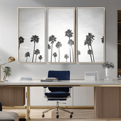 A black and white minimalist scene featuring tall palm trees silhouetted against a bright sky, creating a dreamy and timeless tropical aesthetic.