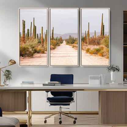 A desert road lined with saguaro cacti under a golden sky, creating a warm southwestern feel, perfect for boho or rustic decor.