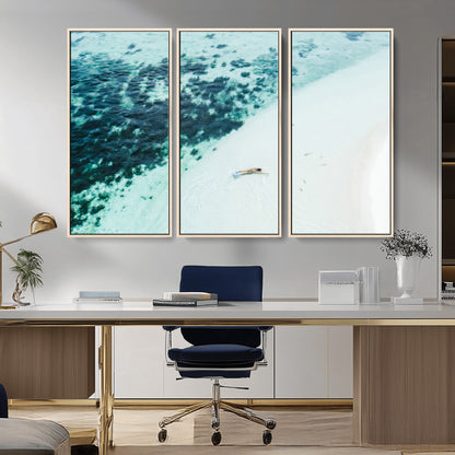 Canvas featuring an aerial view of a swimmer in shallow turquoise waters with coral patterns, ideal for tropical coastal home decor.
