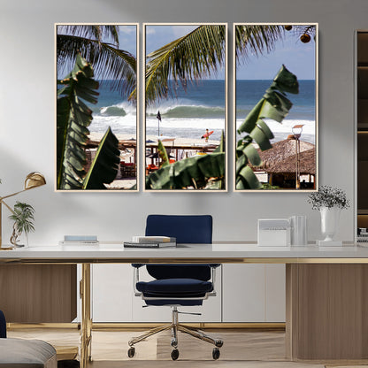 Canvas wall art of a tropical surf scene framed by palm trees, with a surfer on the shore and waves rolling in, ideal for beach-themed decor.