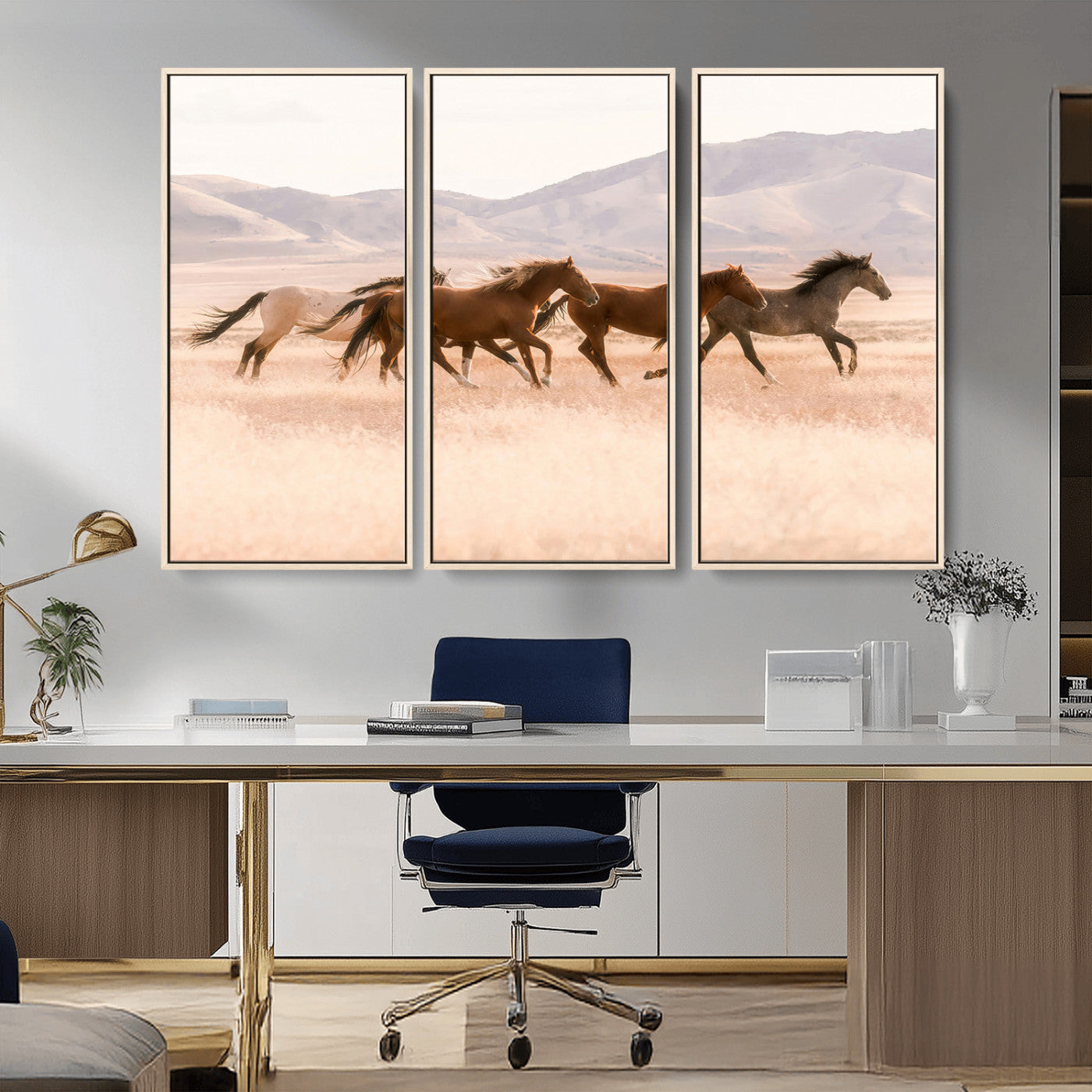 A herd of wild horses galloping through a sunlit desert plain with mountains in the background, perfect for rustic or western-themed wall decor.