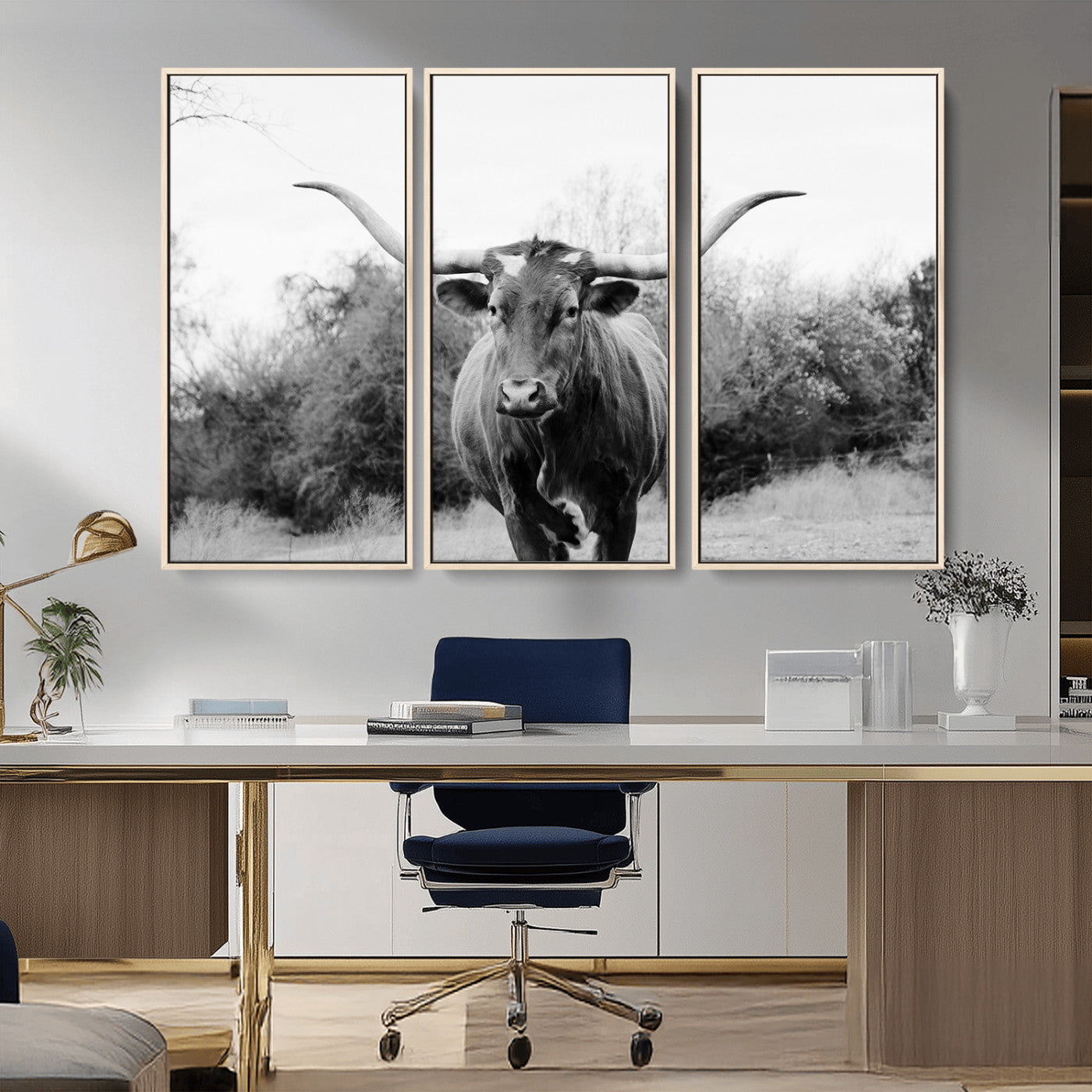 Black and white photo of a longhorn cow in a field, perfect for rustic farmhouse or western-themed interior wall decoration.