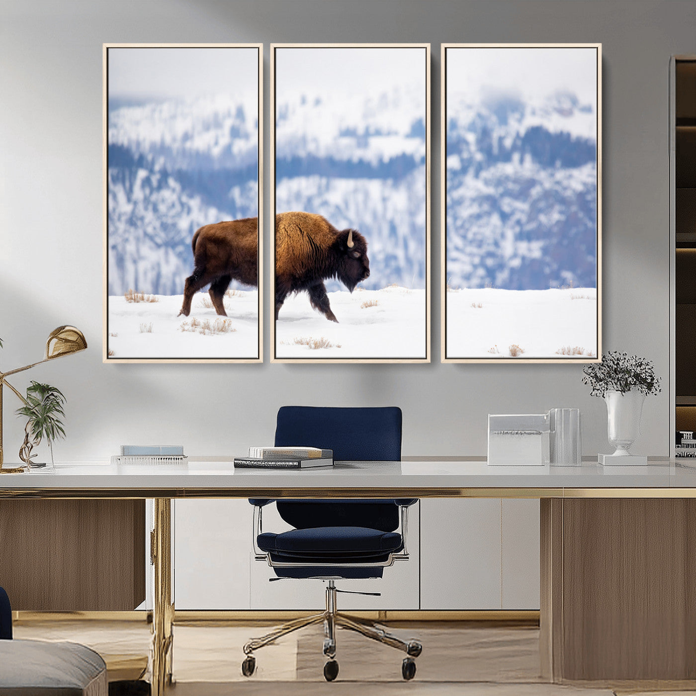 A lone bison walks across snowy ground with blue-toned mountain range behind, ideal for rustic or western farmhouse interiors.