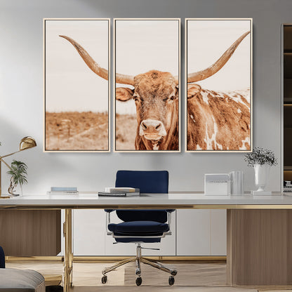 A longhorn bull standing proudly in a sunlit desert field with warm neutral tones, ideal for rustic western or farmhouse interiors.