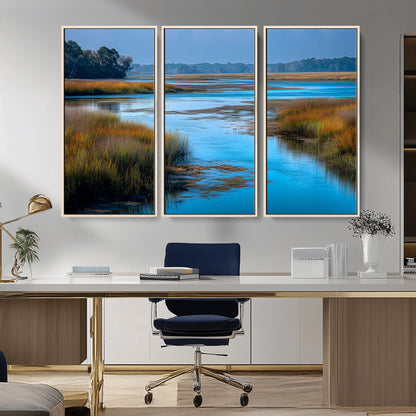 A peaceful marshland scene with calm blue water reflecting the surrounding grasses and trees, capturing the beauty of nature in a serene landscape.