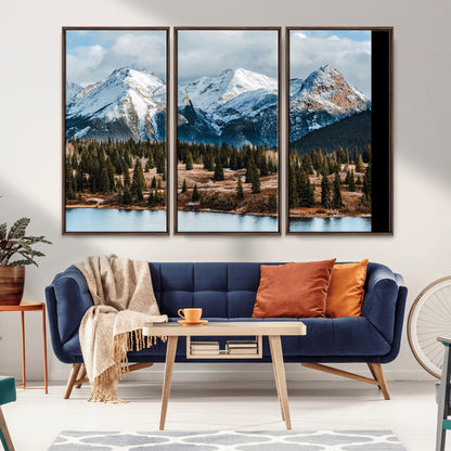 Framed canvas of snowy mountain peaks with pine forest and alpine lake, perfect for winter cabin or wilderness-inspired home decor.