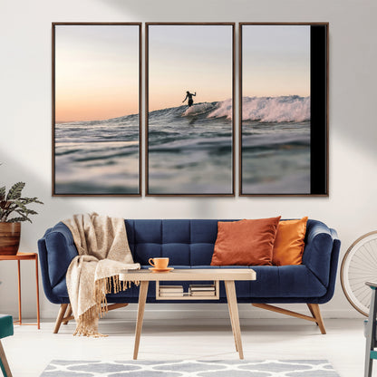 Framed canvas of a female surfer balancing on a wave at sunset, perfect for serene surf or ocean-inspired coastal decor.