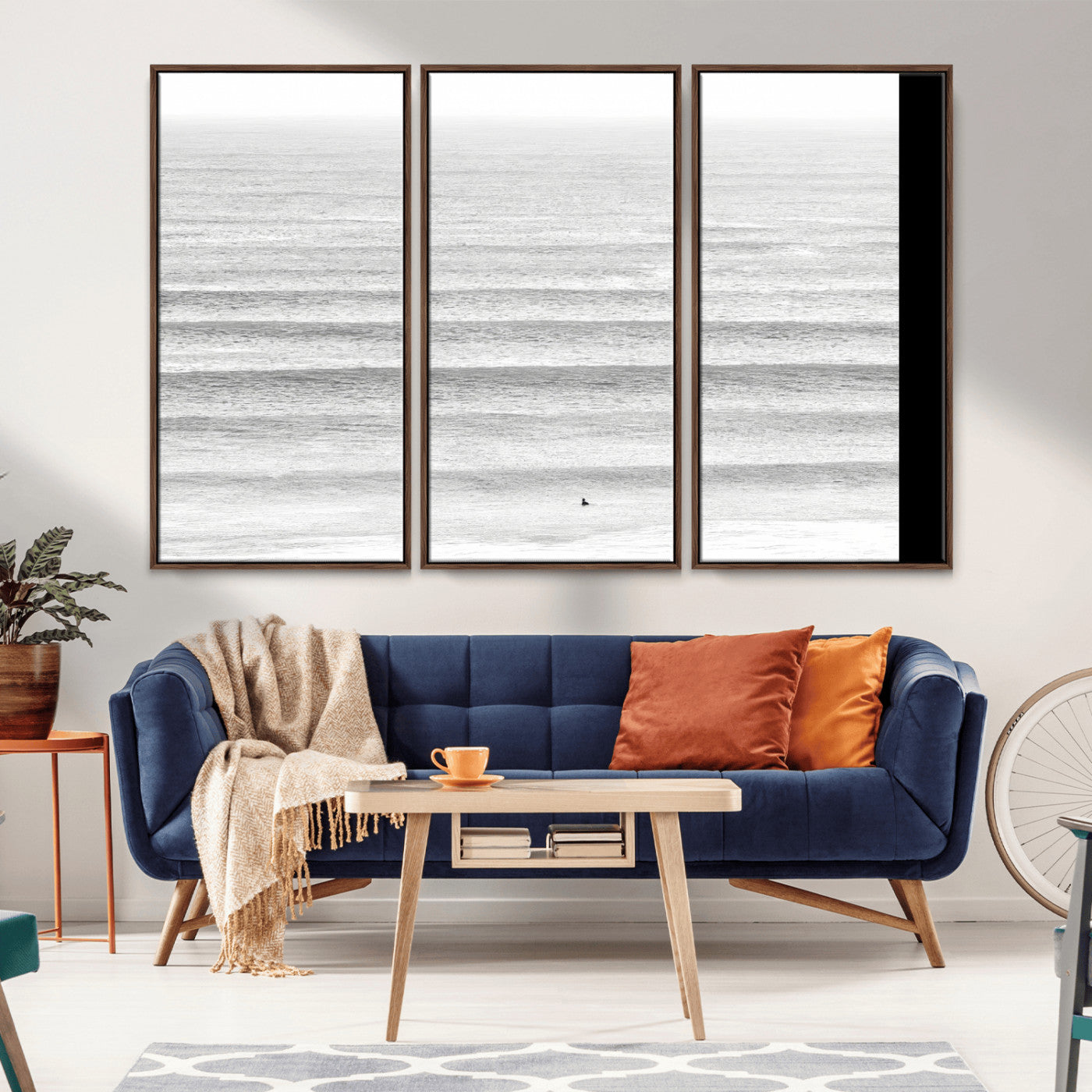 Monochrome photo of a lone surfer in calm layered waves, perfect for minimalist coastal or moody ocean-inspired wall decoration.
