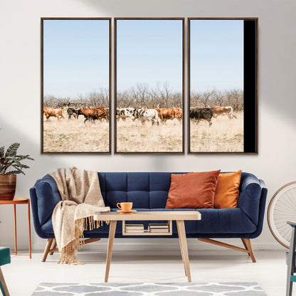 Framed wall art of Texas longhorn cattle walking through a dry, neutral-toned prairie, perfect for rustic farmhouse or western-themed home decor.