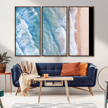 Aerial photo of soft blue waves meeting sandy shore, perfect for modern coastal or beach-themed decor with a light and tranquil aesthetic.