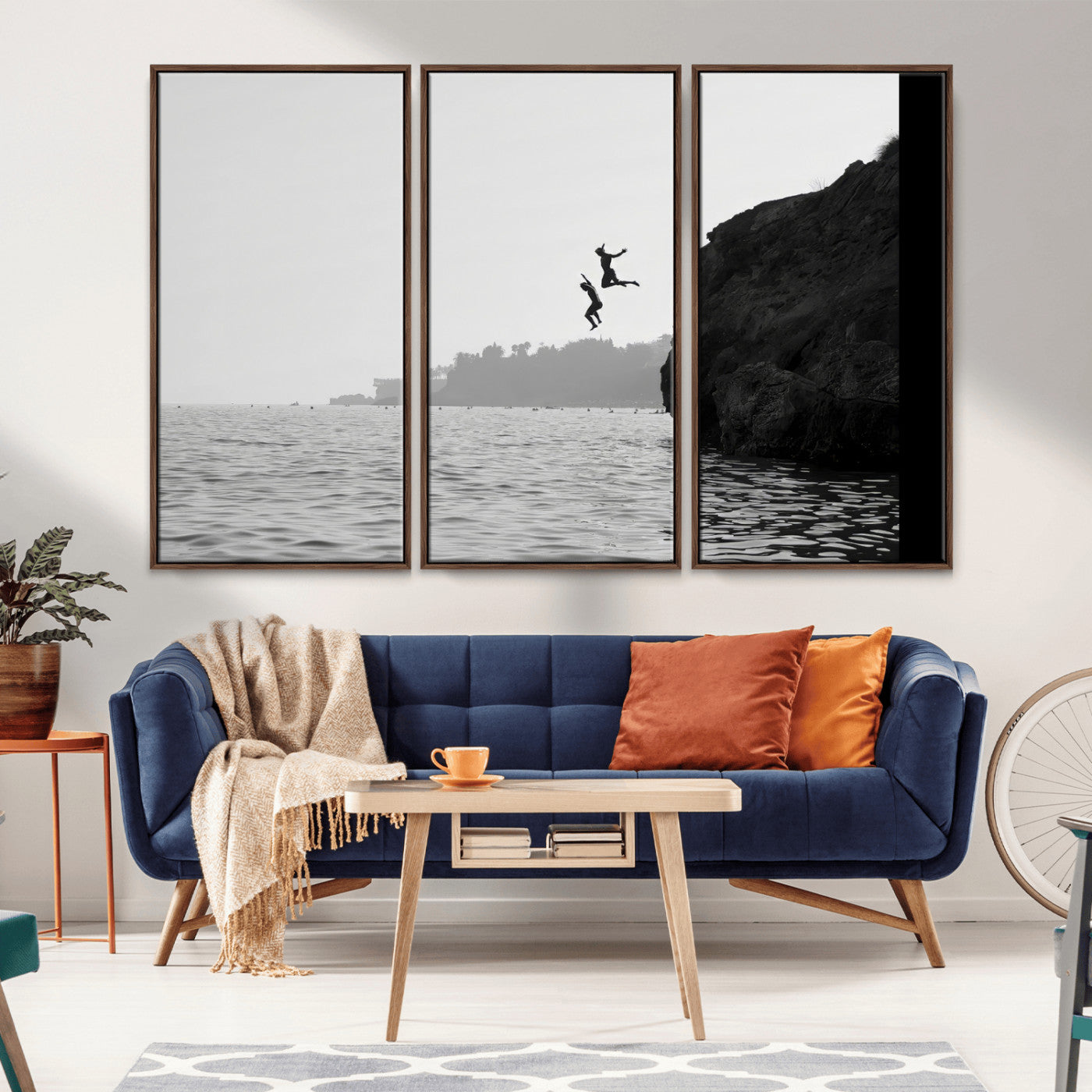Black and white canvas of two figures cliff jumping into the sea, captured with moody tones, ideal for modern coastal or adventure-themed home decor.   2/2