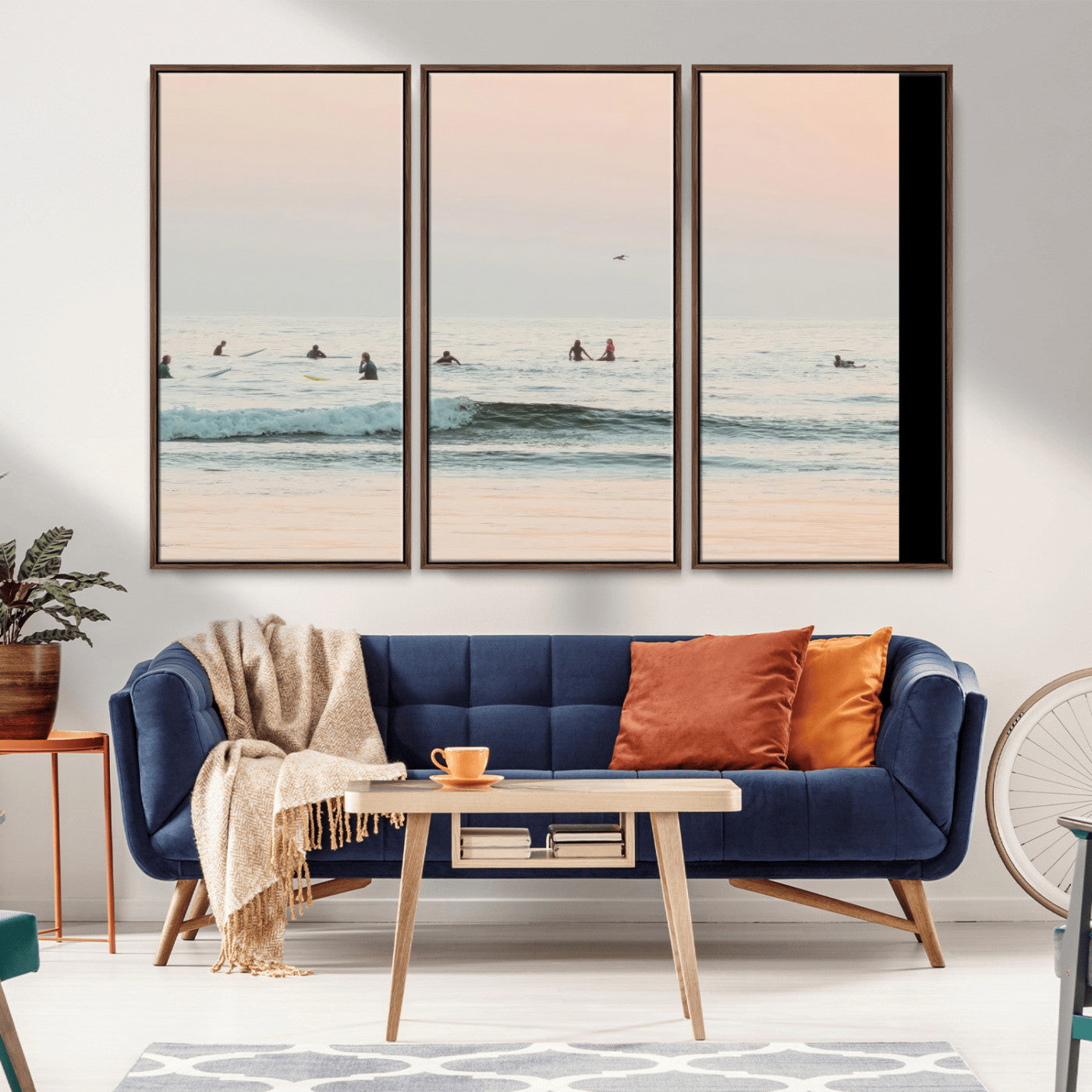 Dreamy photo of surfers waiting on soft pastel waves under a pink sunset sky, ideal for soft coastal minimalist or serene ocean-themed home decor.