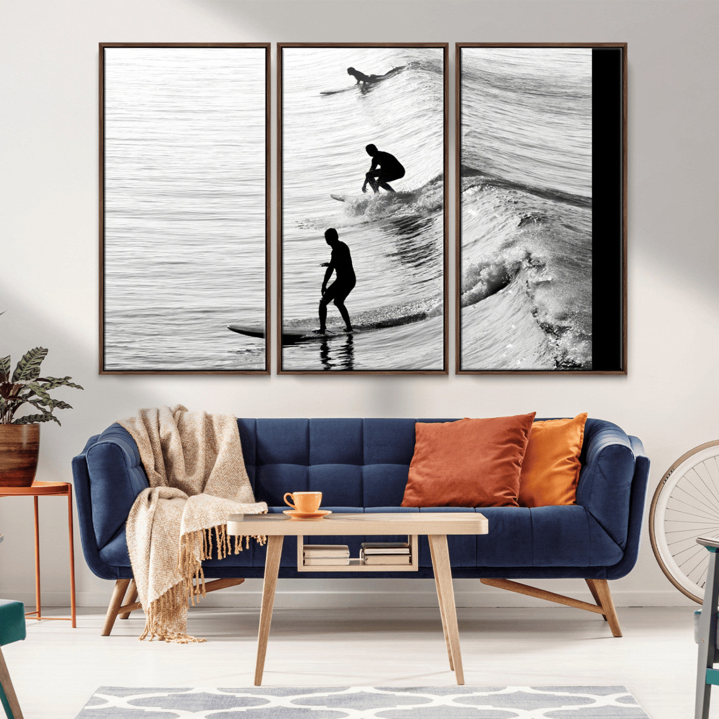 Black and white photo of surfers riding waves in a moody, high-contrast scene, ideal for modern coastal or surf-inspired home decor.