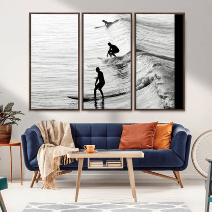 Black and white photo of surfers riding waves in a moody, high-contrast scene, ideal for modern coastal or surf-inspired home decor.