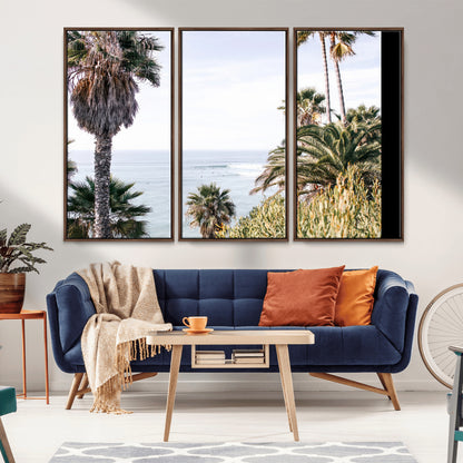 Scenic coastal view with tall palm trees overlooking a calm ocean, soft blue waves, and surfers in the distance, creating a peaceful tropical vibe.
