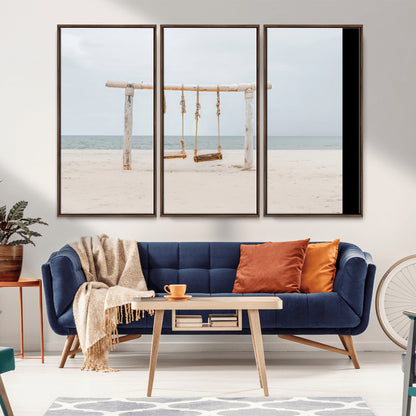 A rustic wooden beach swing stands on a serene sandy shore with an ocean horizon in the background, creating a tranquil and dreamy coastal escape.