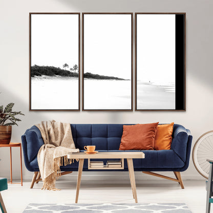 A black and white minimalist coastal scene with a vast open beach, distant palm trees, and a lone figure walking along the shoreline, evoking serenity and solitude.