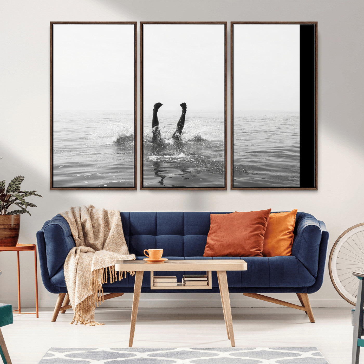 A black and white minimalist water scene capturing a playful splash as a swimmer dives upside down, creating a carefree and artistic aquatic aesthetic.