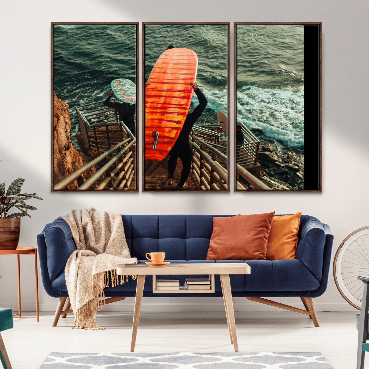 A surfer carrying a bold orange surfboard down a rugged staircase toward the ocean, bathed in golden hour light, capturing the energy of coastal adventure.
