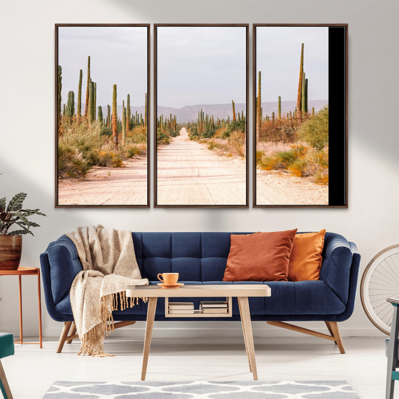 A desert road lined with saguaro cacti under a golden sky, creating a warm southwestern feel, perfect for boho or rustic decor.