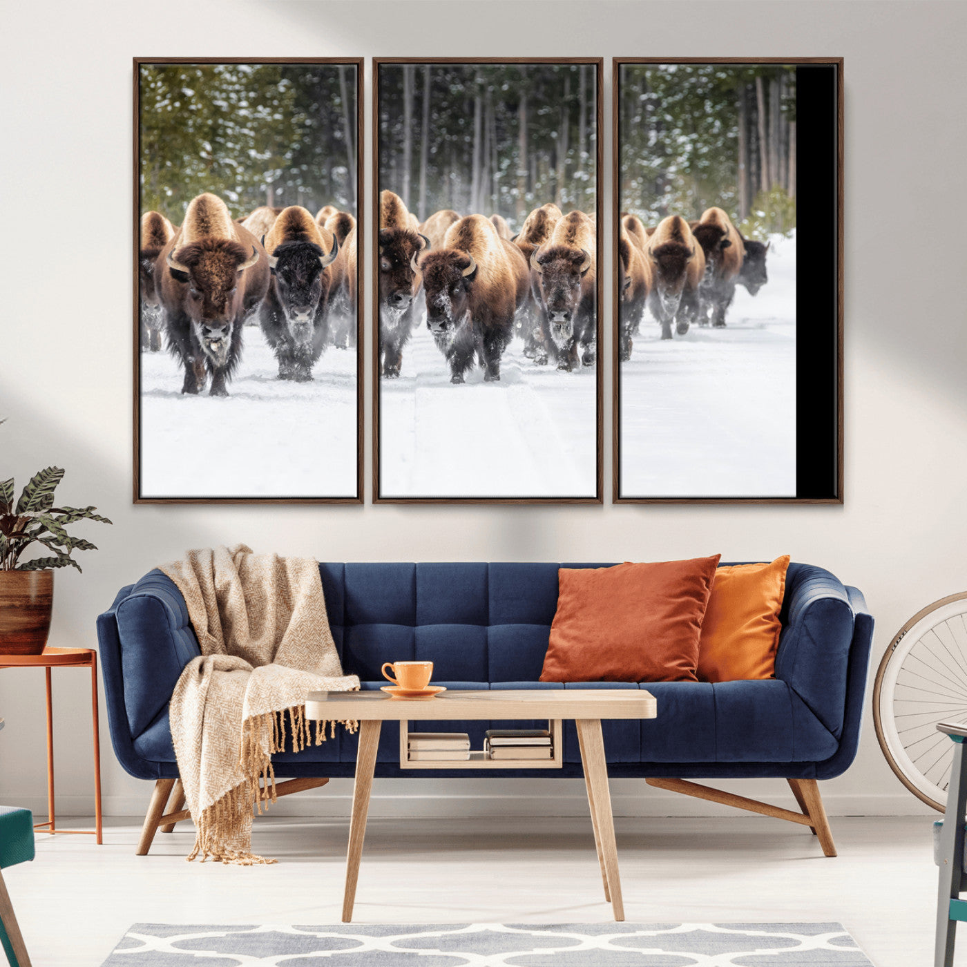 A herd of American bisons walking through a snowy forest path, perfect for rustic cabin or Western-themed wall decor.