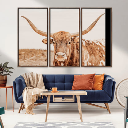 A longhorn bull standing proudly in a sunlit desert field with warm neutral tones, ideal for rustic western or farmhouse interiors.