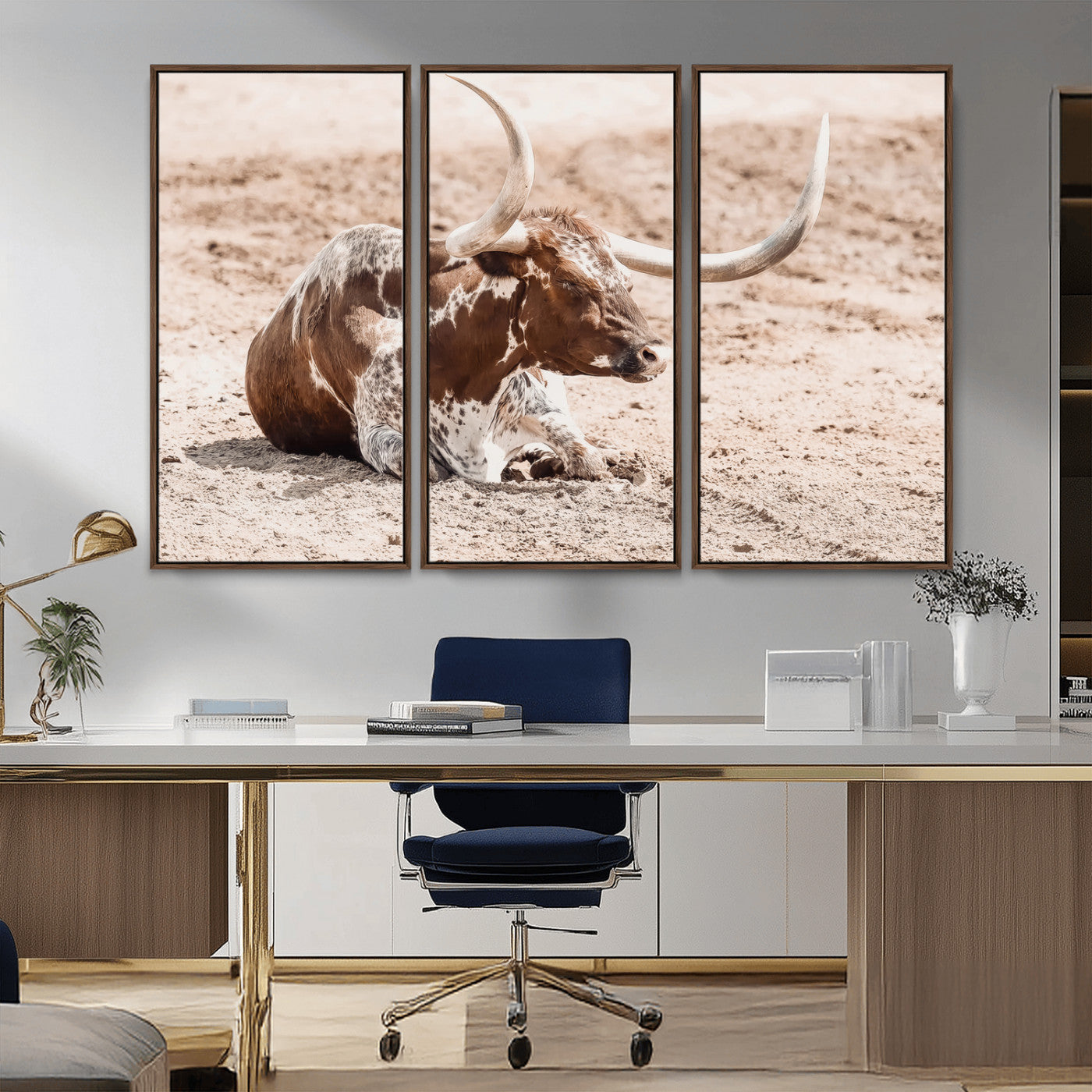 Texas Longhorn bull resting on dusty ground with warm tones, ideal for rustic western or farmhouse-themed wall decor.
