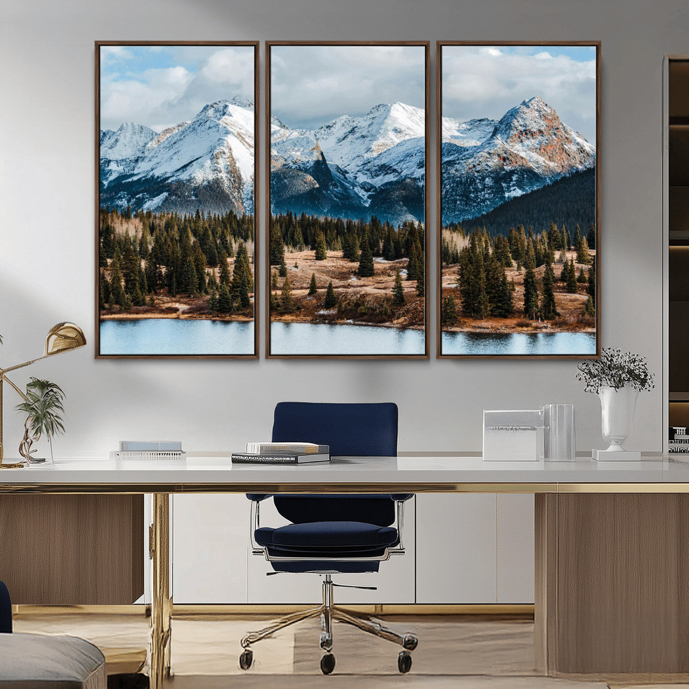 Framed canvas of snowy mountain peaks with pine forest and alpine lake, perfect for winter cabin or wilderness-inspired home decor.