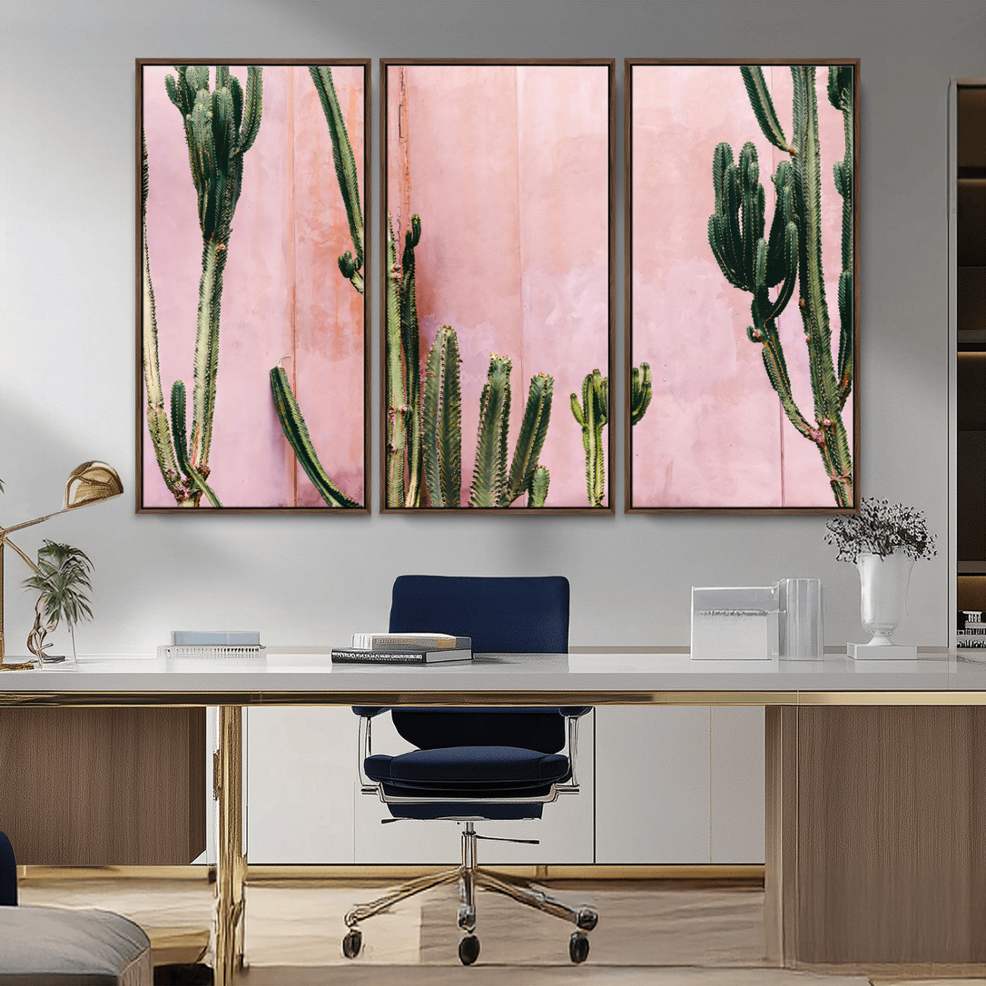 Framed canvas of tall green cacti against a soft pink wall, ideal for modern desert or colorful southwest-inspired home decor.