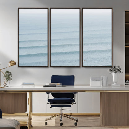 Framed canvas of repeating ocean waves with a distant solo surfer, ideal for minimalist ocean or calm coastal wall decor.