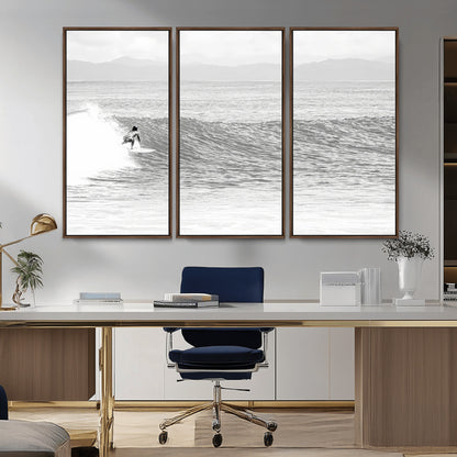 Monochrome photo of a surfer riding a wave with distant mountains, ideal for coastal motion or black and white surf-themed wall decor.