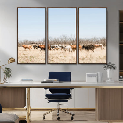 Framed wall art of Texas longhorn cattle walking through a dry, neutral-toned prairie, perfect for rustic farmhouse or western-themed home decor.