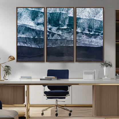 Canvas of aerial ocean waves crashing onto a black sand beach in moody tones, ideal for modern coastal or minimalist home decor.