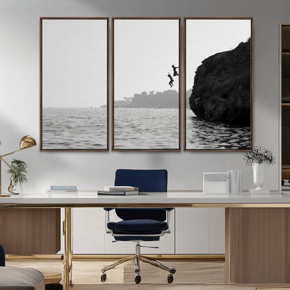 Black and white canvas of two figures cliff jumping into the sea, captured with moody tones, ideal for modern coastal or adventure-themed home decor.   2/2