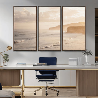 Golden hour seascape with misty cliffs and gentle waves rolling towards the shore, capturing a tranquil and warm coastal atmosphere.