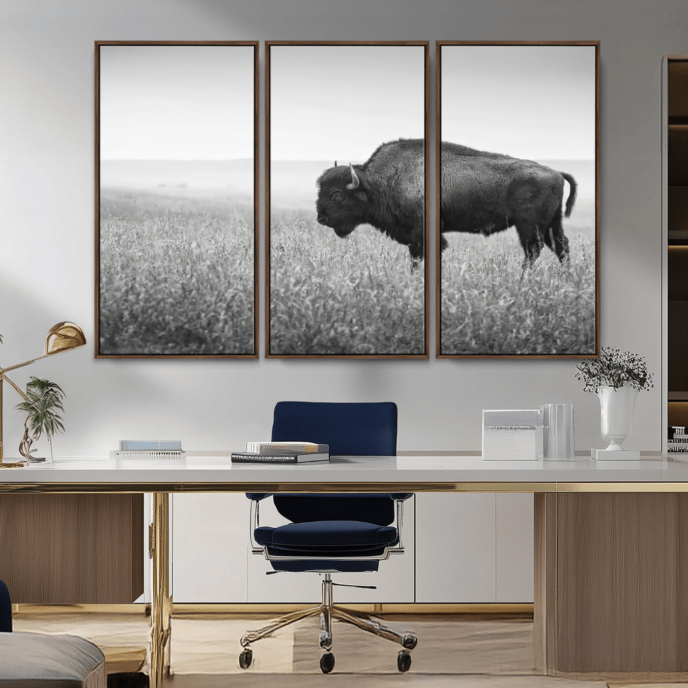 A black and white photograph of a majestic bison standing in a vast grassy prairie, evoking a sense of wilderness and strength.